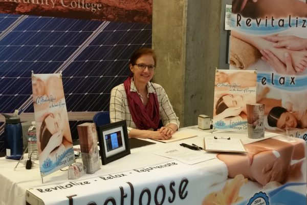 AnnMarie (owner of Footloose Massage Center) at the 2018 LCC Job Fair with elaborate table setup